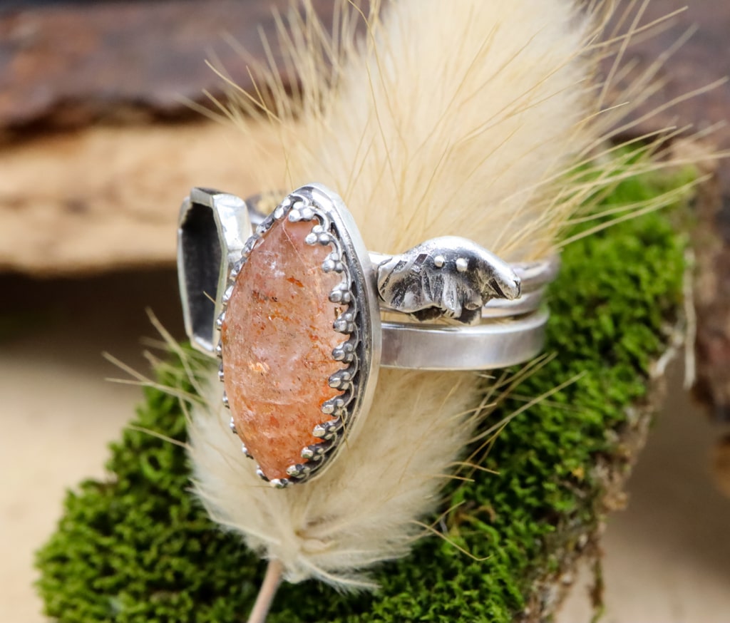 A side view of the sterling silver rings featuring the tiny ghost.