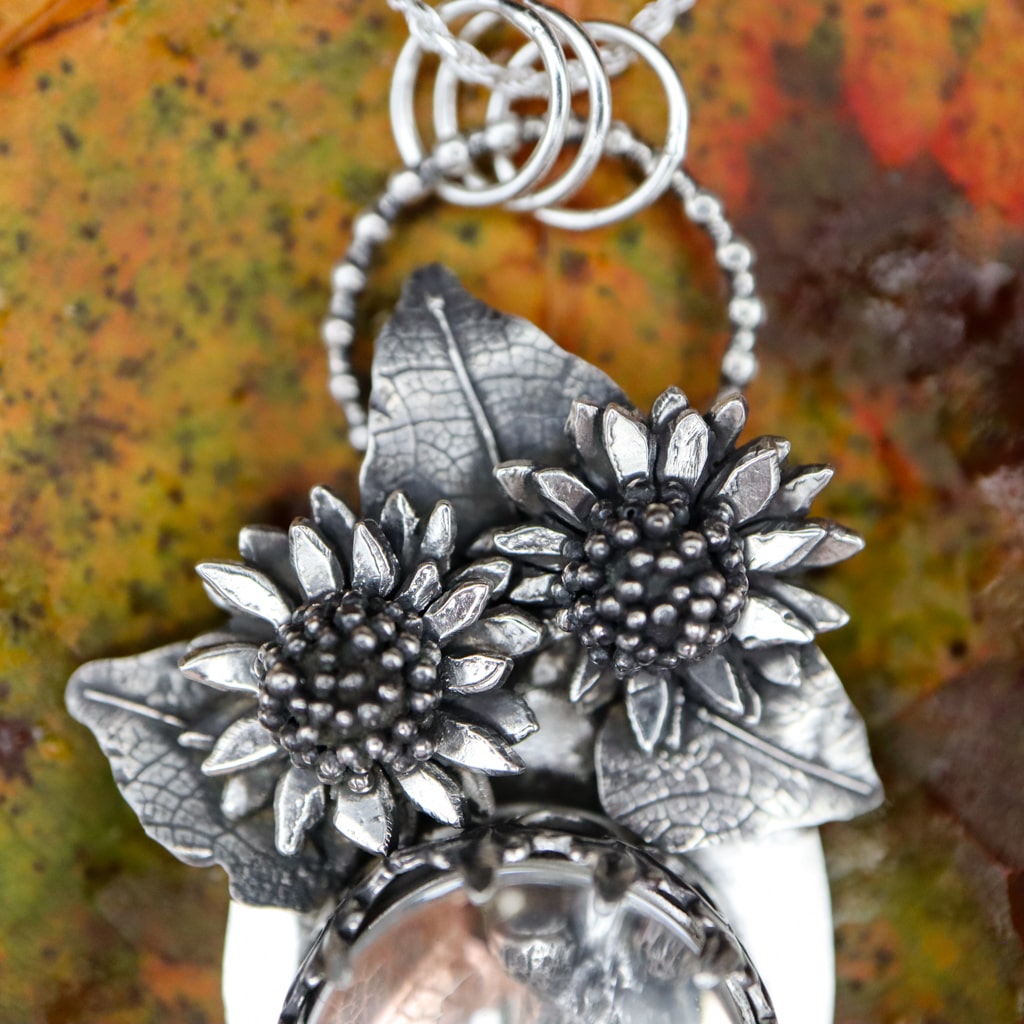 A close up of the sterling silver sunflowers at the top of the necklace.