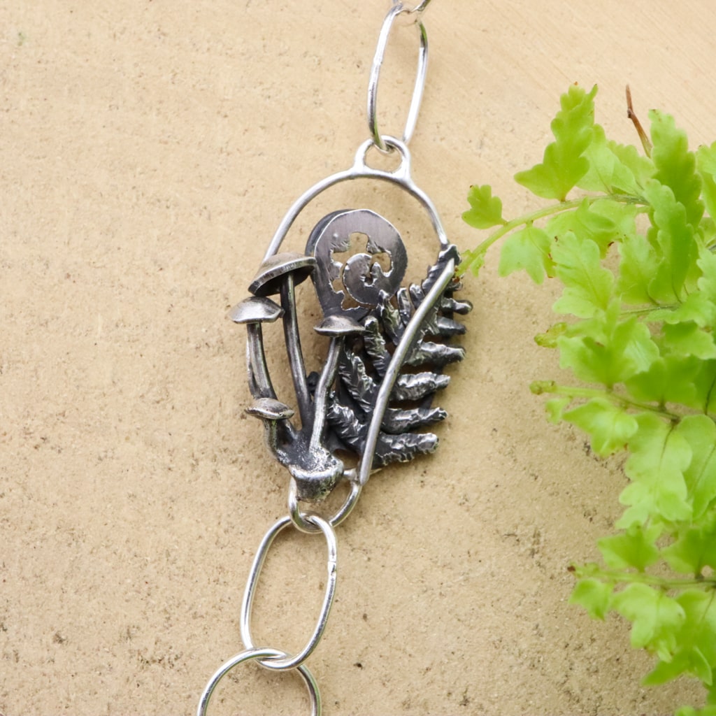 The second link that has mushrooms and tiny silver ferns within it.