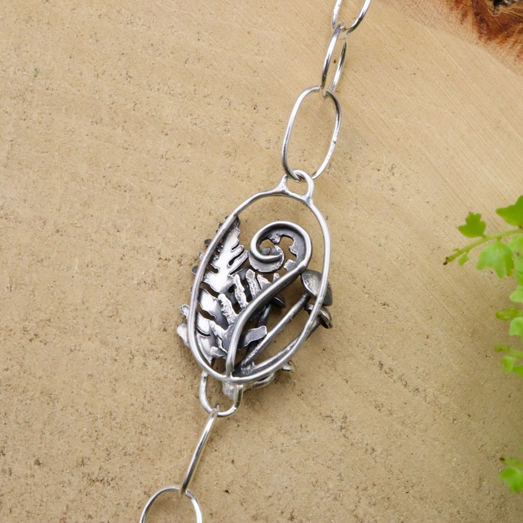 the back of the second line that has a curled fern.