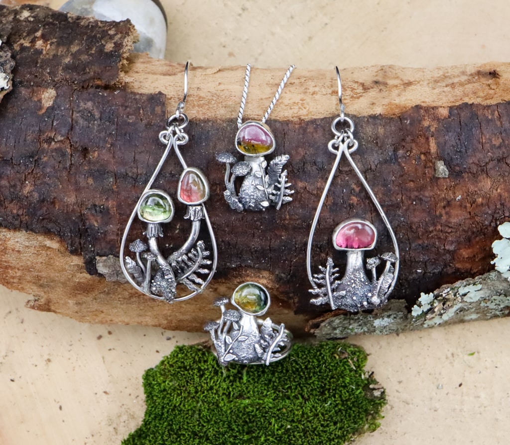 A set of earrings, ring, and necklace that all match the watermelon tourmaline mushroom theme.