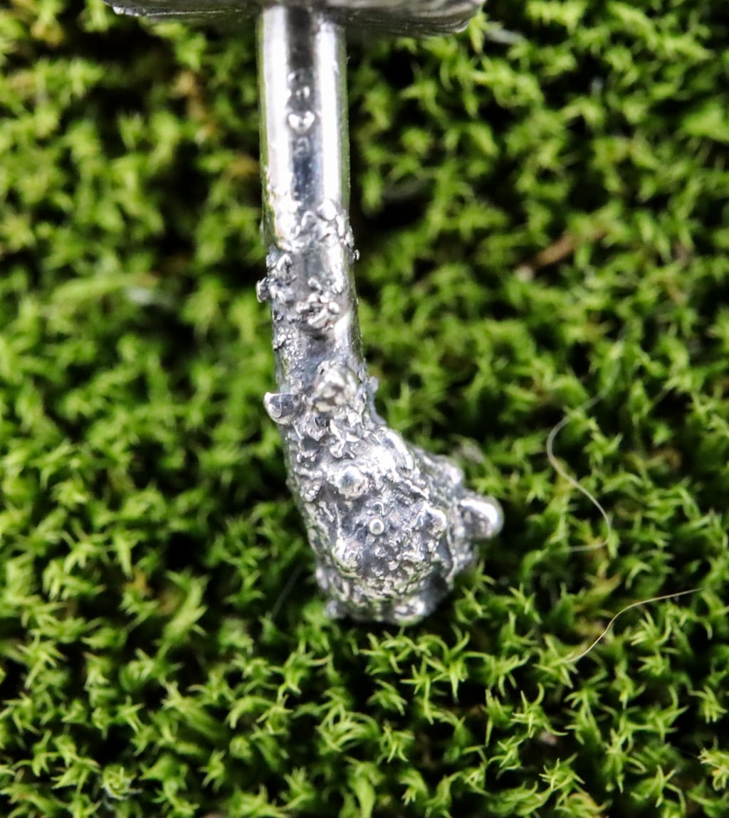 The bottom stem part of the mushroom stud earrings showing all the little details.
