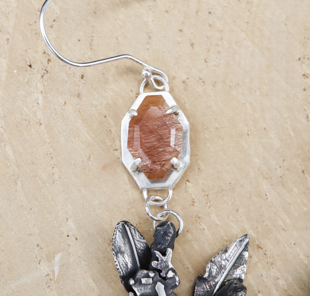 A close up photo of the copper colored rutilated agate gemstones.