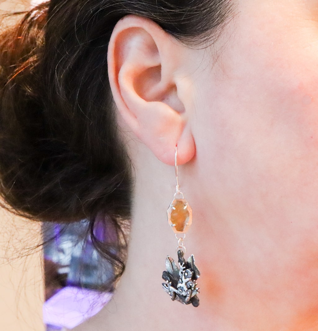 The sterling silver handmade spring peeper frog earrings are shown being worn. They are about 3 inches long.