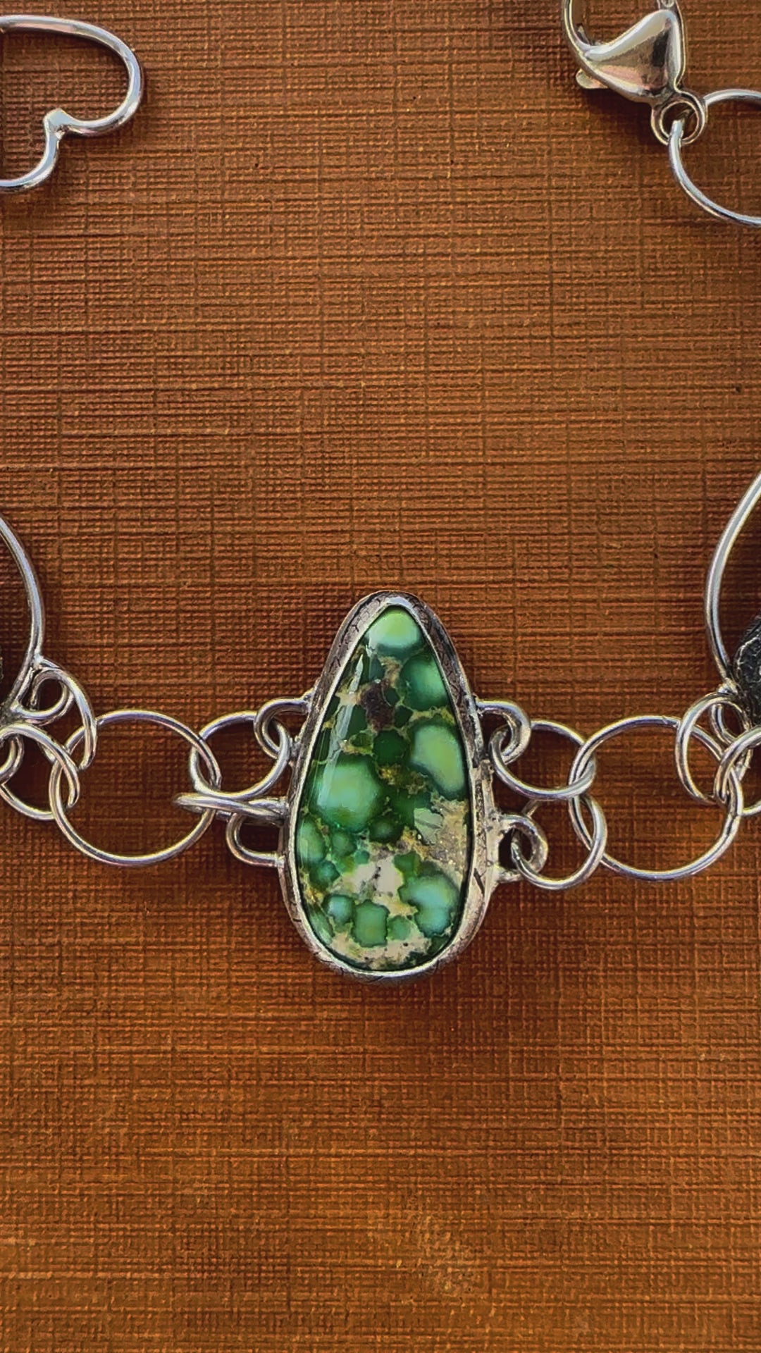 A close up video of the turquoise and chickadee bracelet on top of a vintage book called, Everyday Doings of Insects.