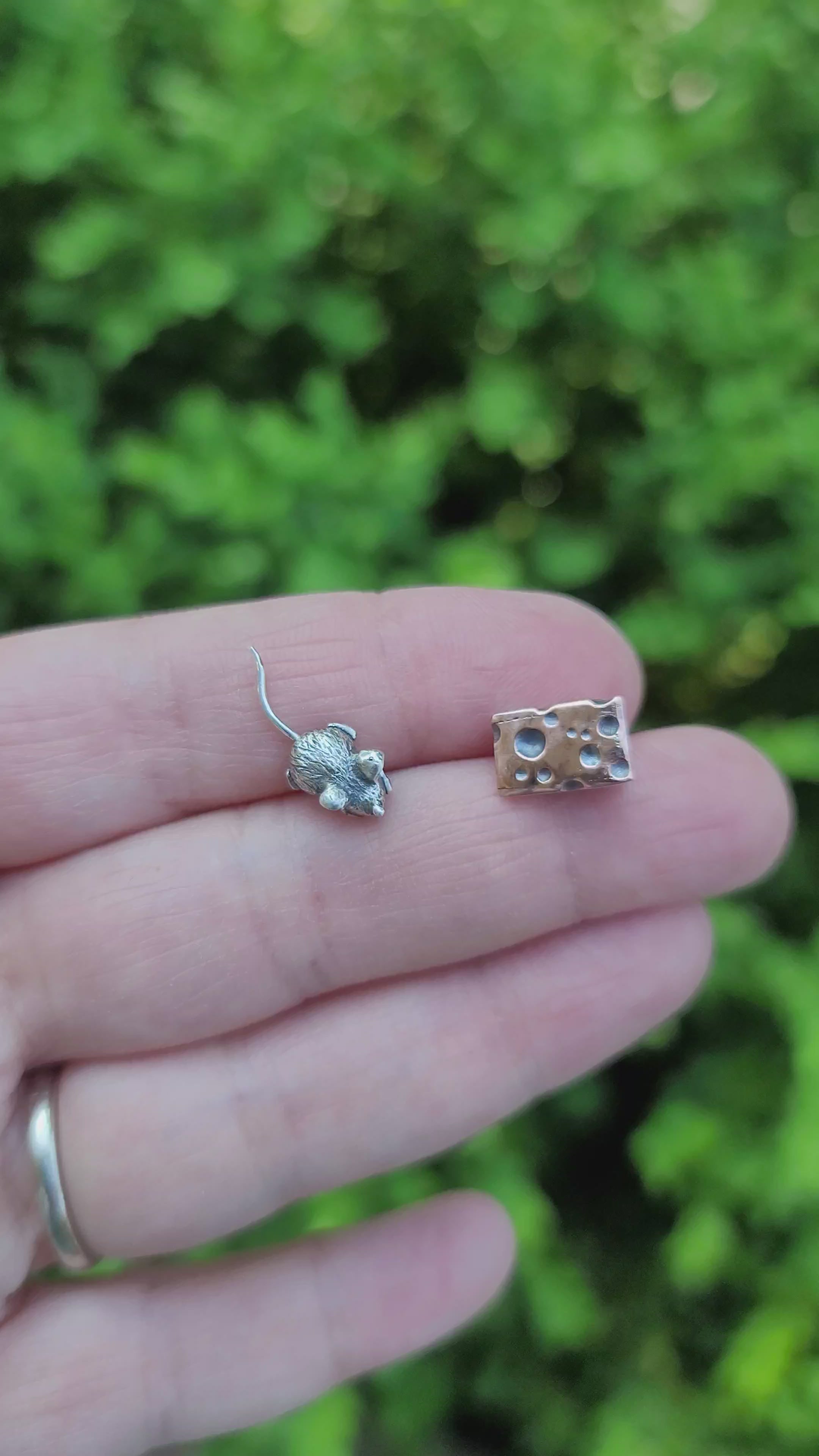 A video is showing both the tiny silver mouse and the 3 dimensional piece of copper swiss cheese.