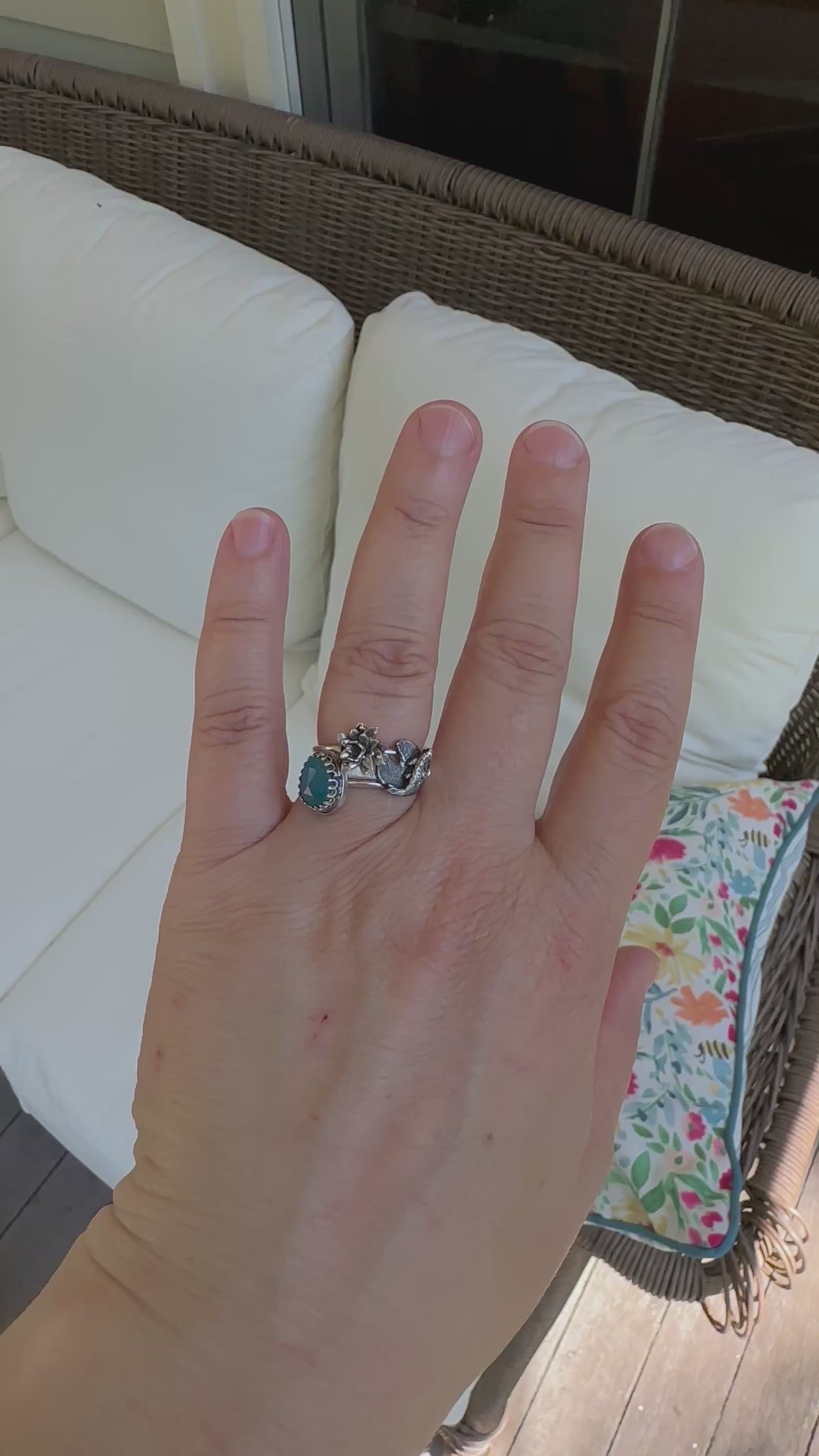 A movie of the goldfish and lily pad stacking rings being worn in the sunshine and in the shade.