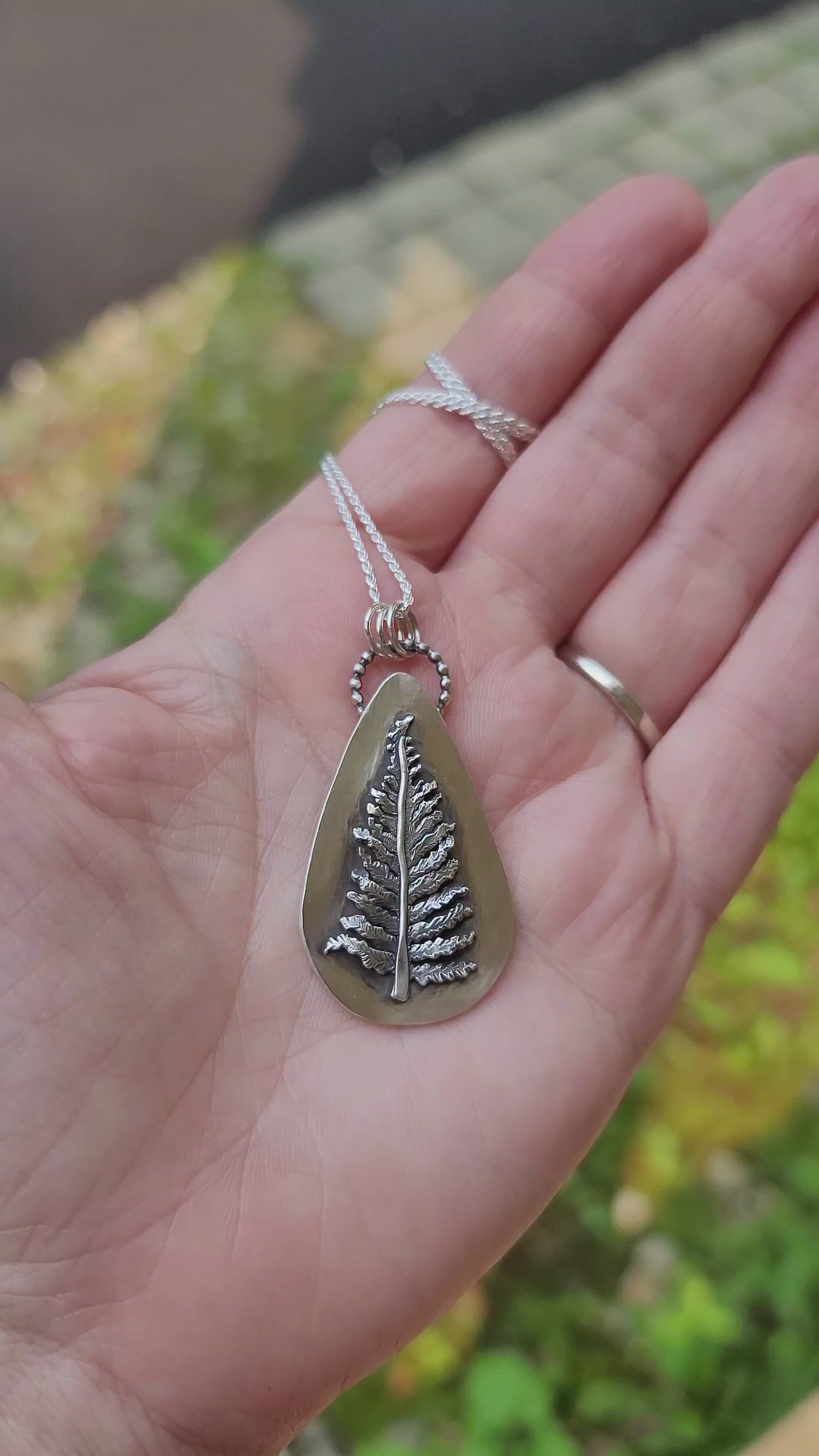 A video showing the handmade sterling silver fern necklace at all angles. It has a lot of texture.