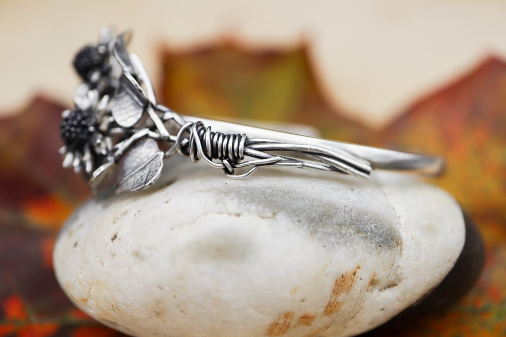 A close up photo of the sunflower stems on the side of the bracelet.