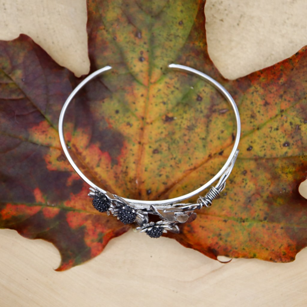 A top down view of the sunflower bracelet. There is an opening in the back of the bracelet so that it can be adjustable.