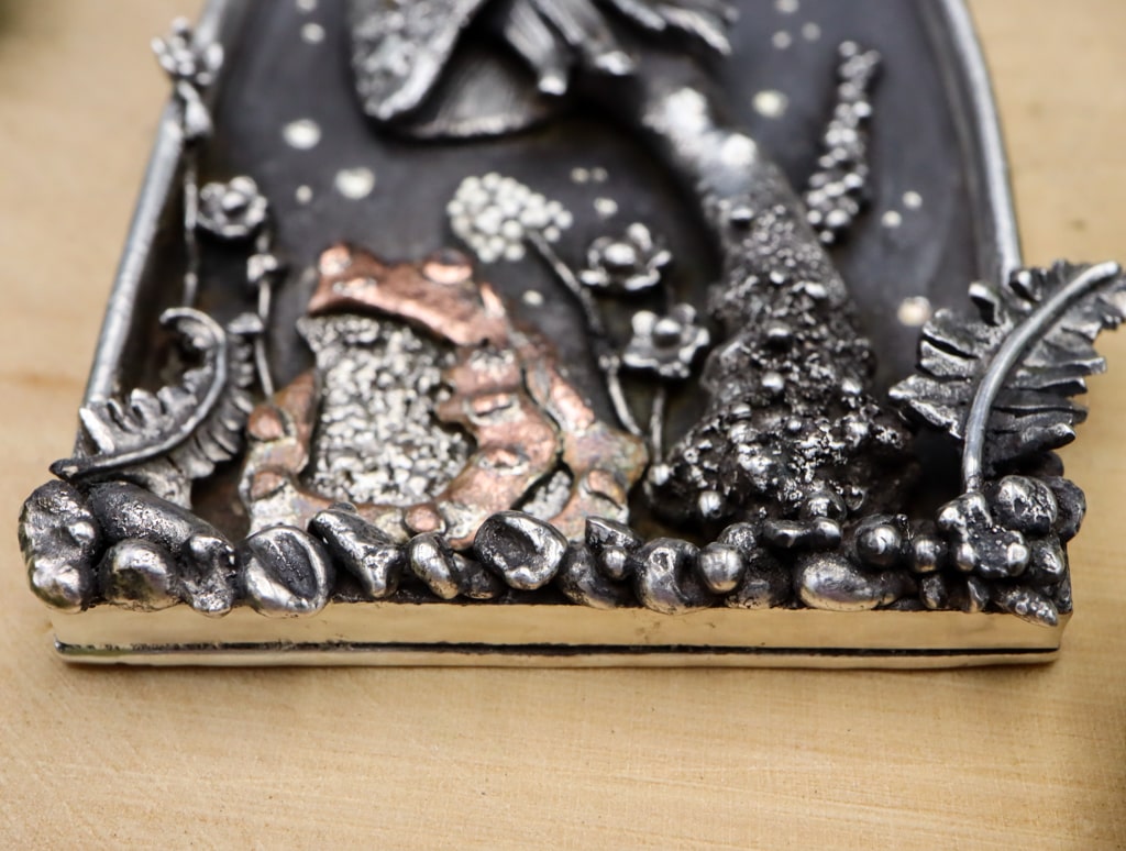 A bottom view of the pendant showing its thickness.