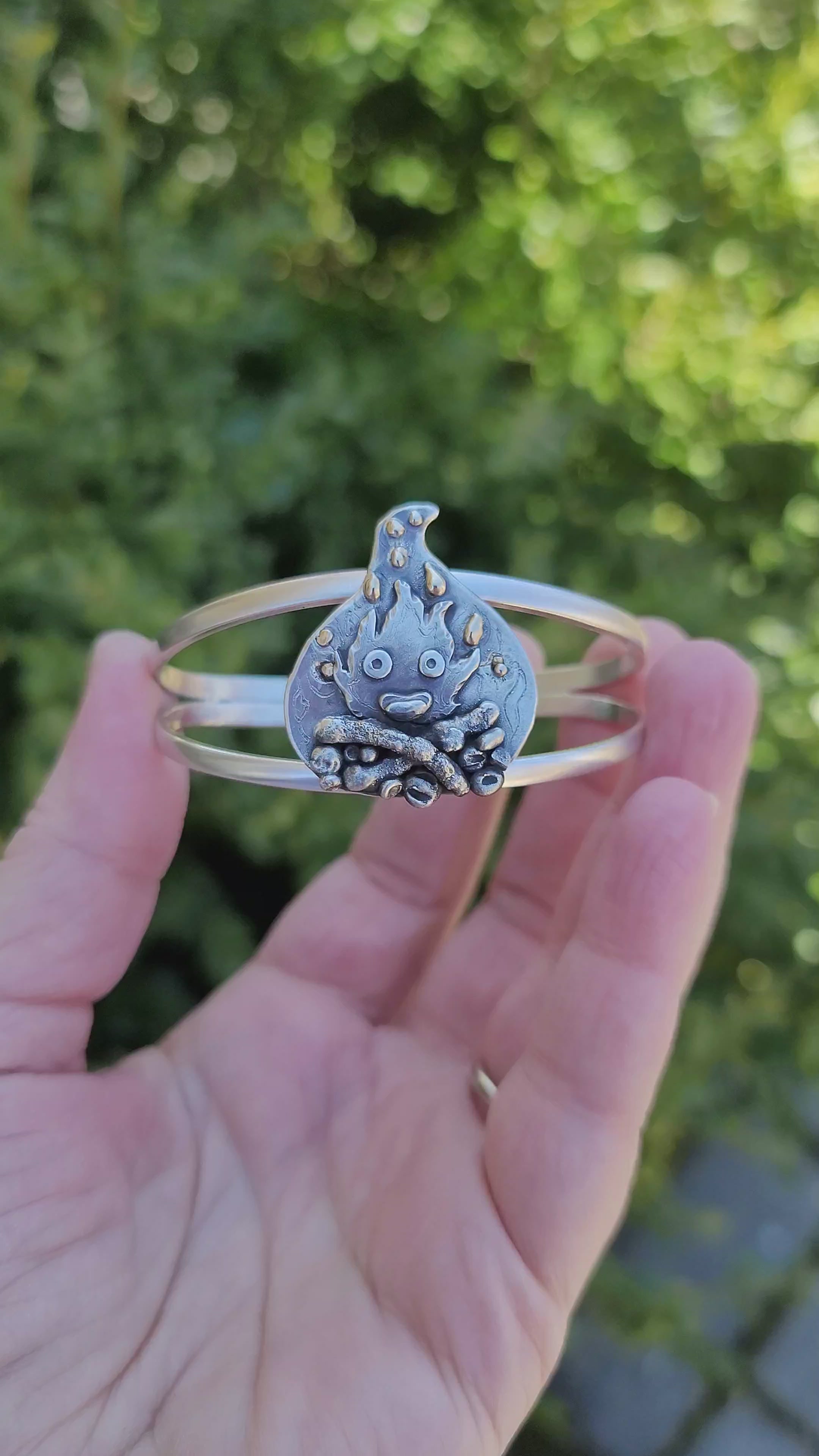 Another video of the bracelet being held in a hand.
