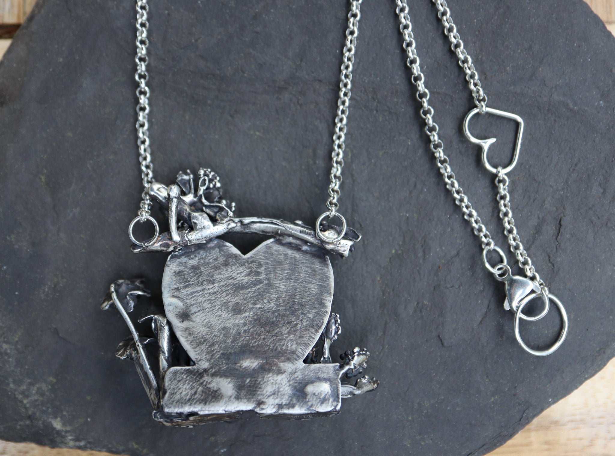 The back of the pendant showing the necklace and the heart connection to close the necklace making it shorter if needed.