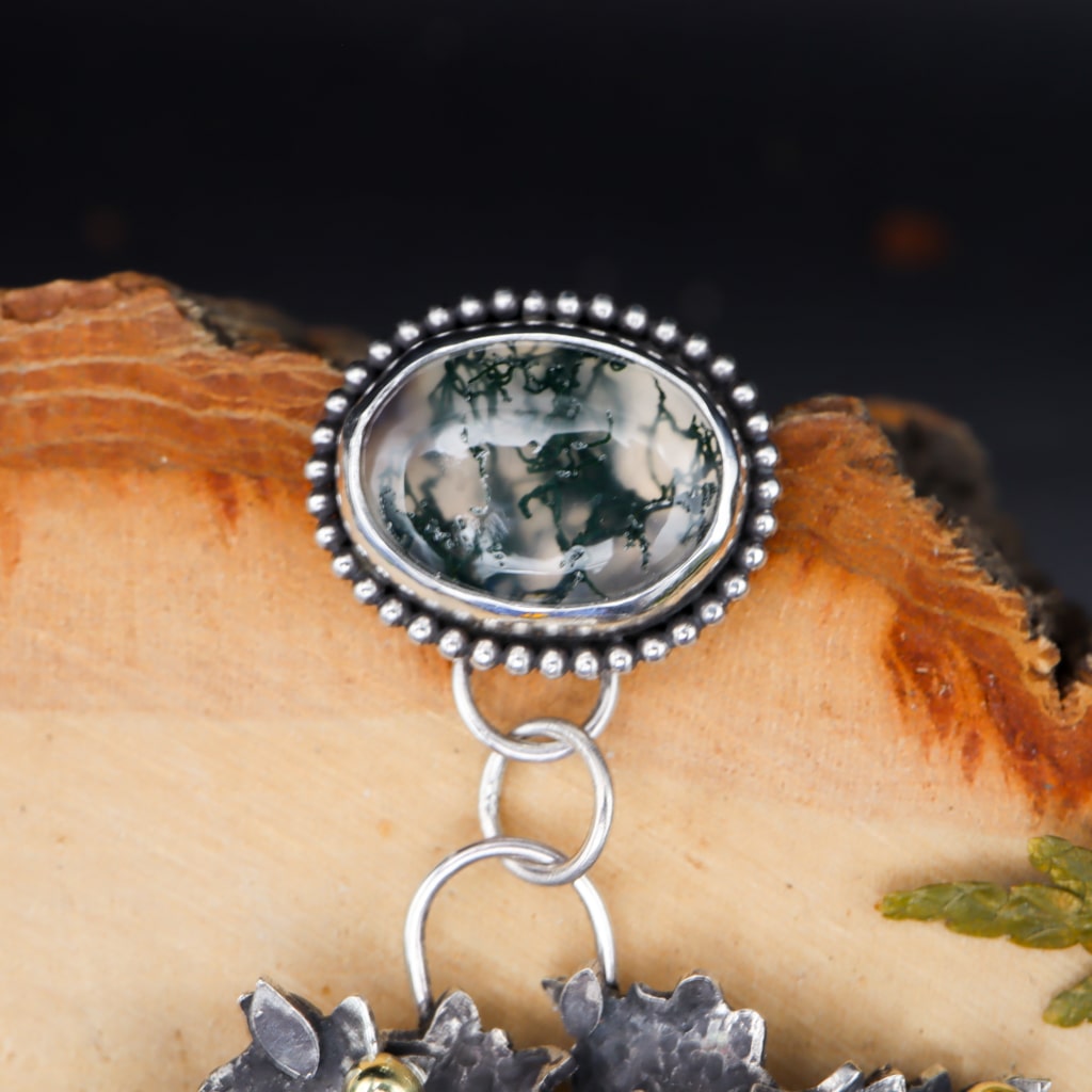 A close up photo of the clear and deep green moss agate stone.