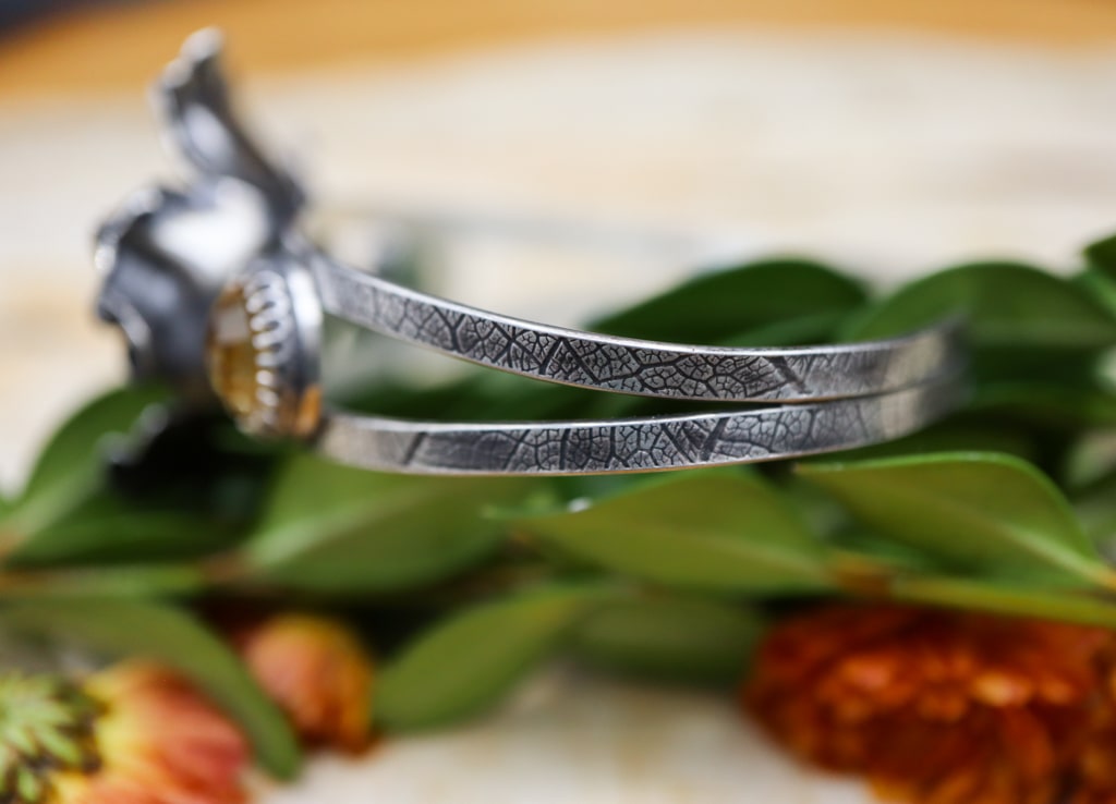 A close up photo of the lead vein pattern bracelet bands making the one of a kind.