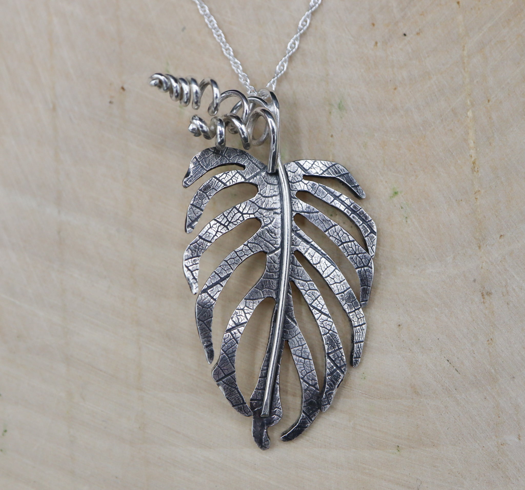 A handmade sterling silver monstera sierrana necklace.