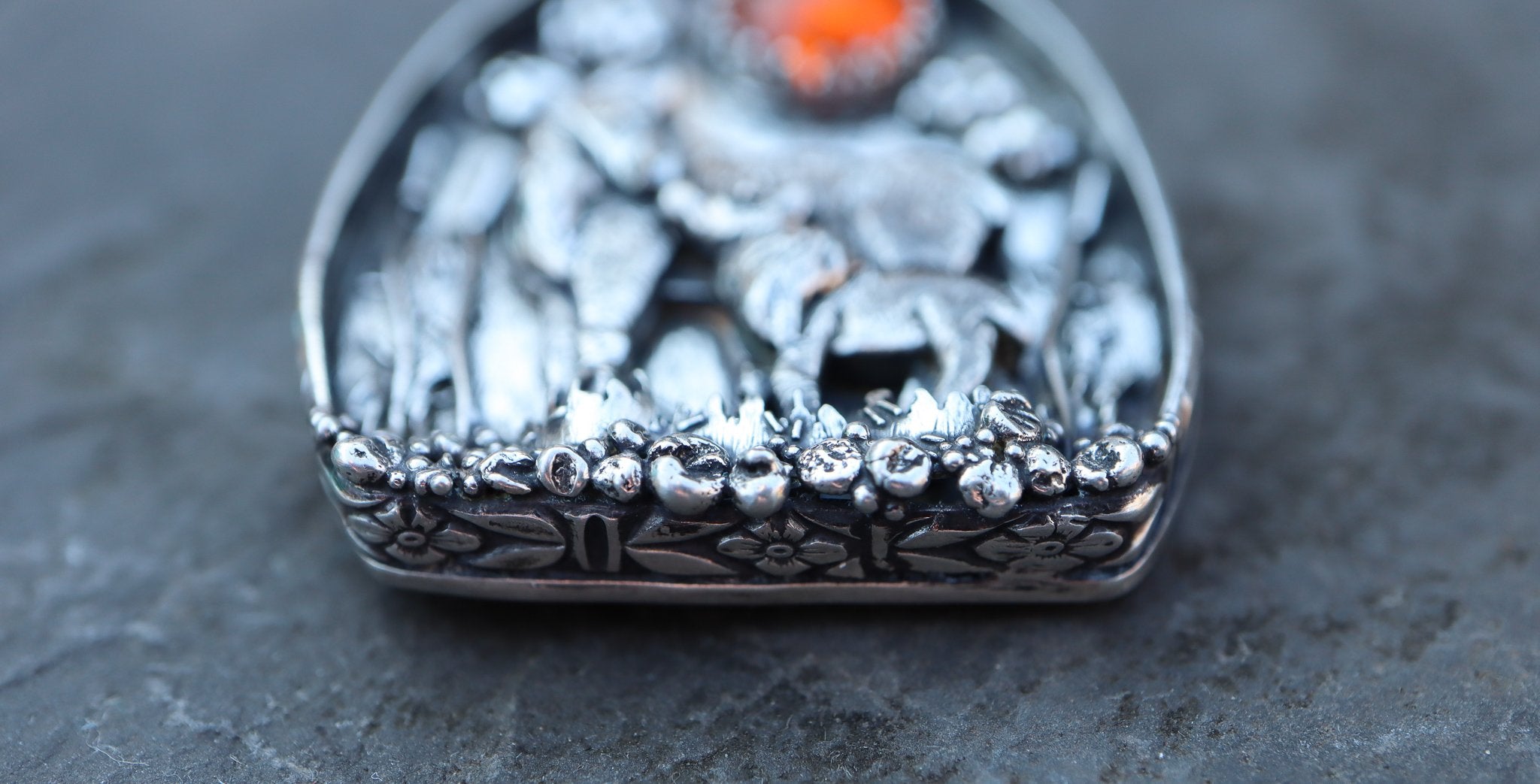 The bottom view of a handmade moose pendant made by The Striped Cat Metalworks.