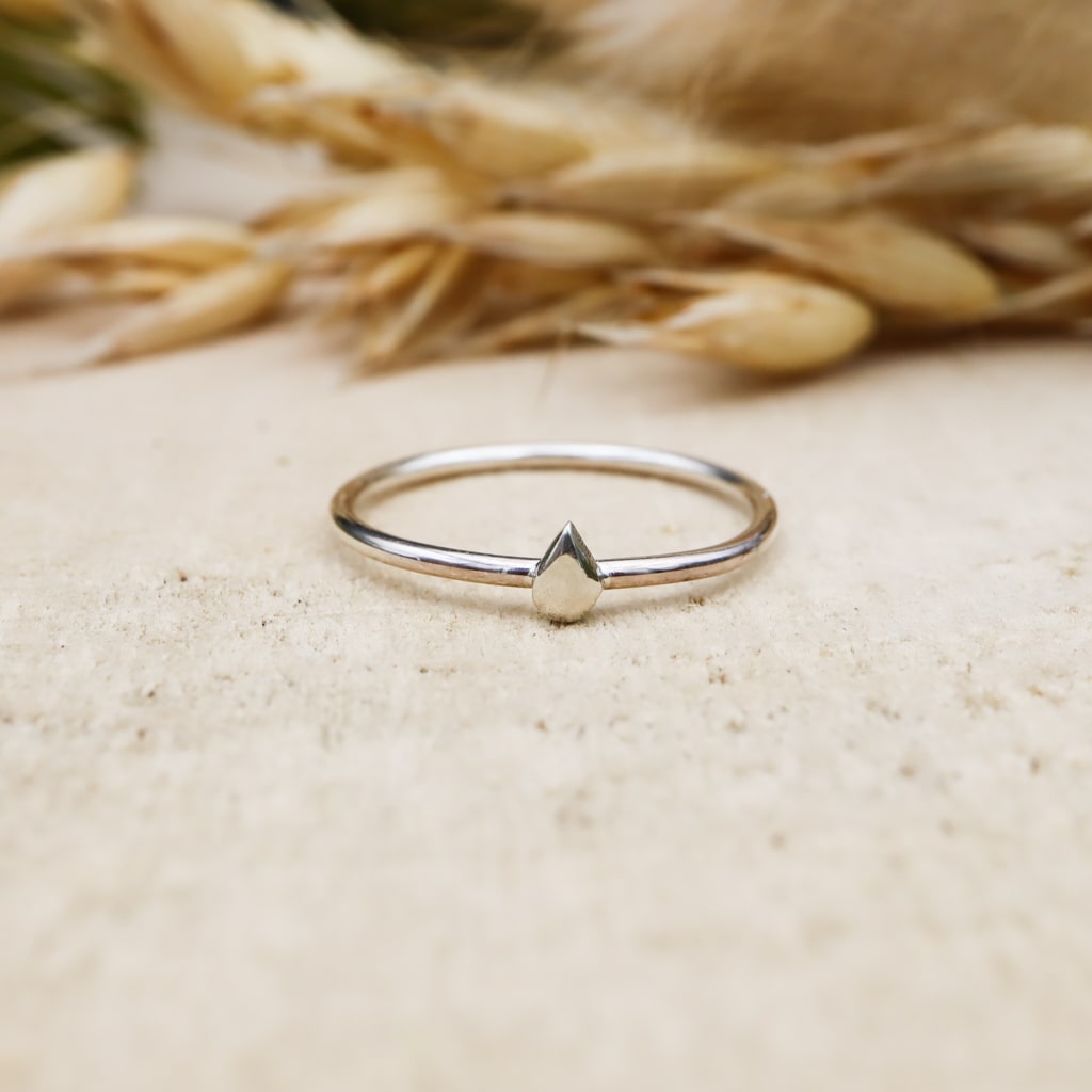 A single tiny rain drop ring made from sterling silver.