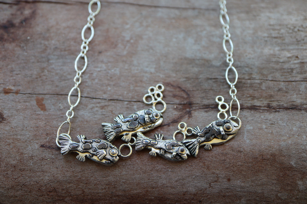 Another photo of all four of the fish on the sterling silver necklace.