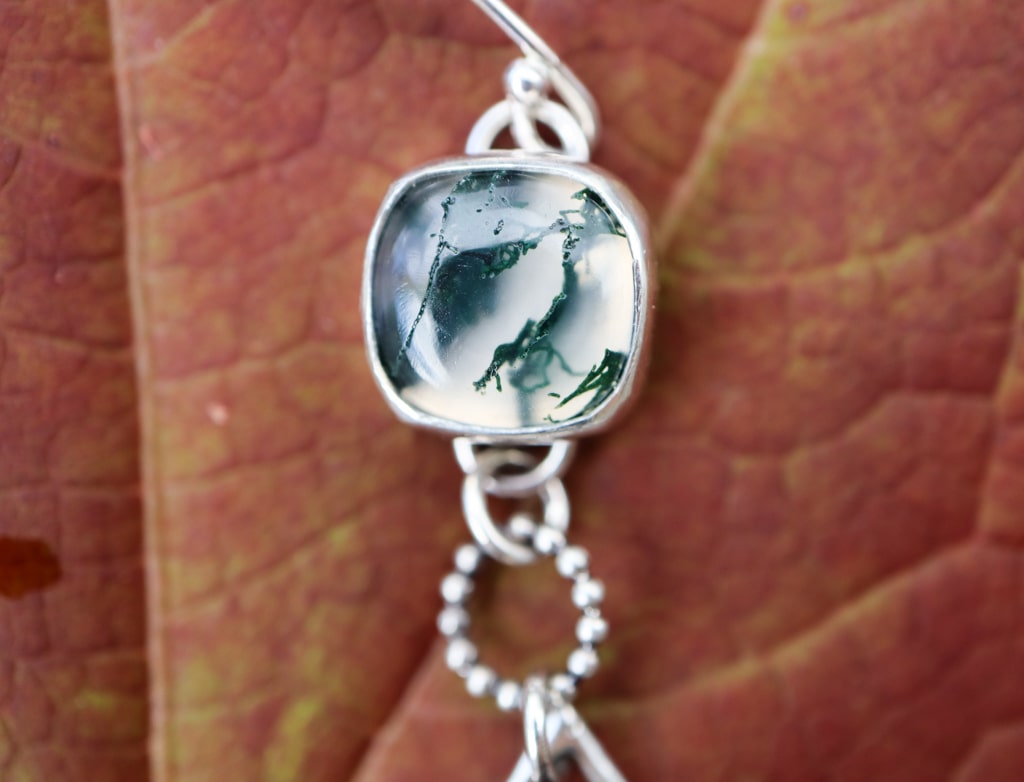 The second clear and dark green moss agate gemstones.
