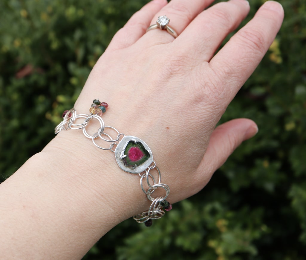 The bracelet being worn on a hand. The bracelet is about 8 inches long.