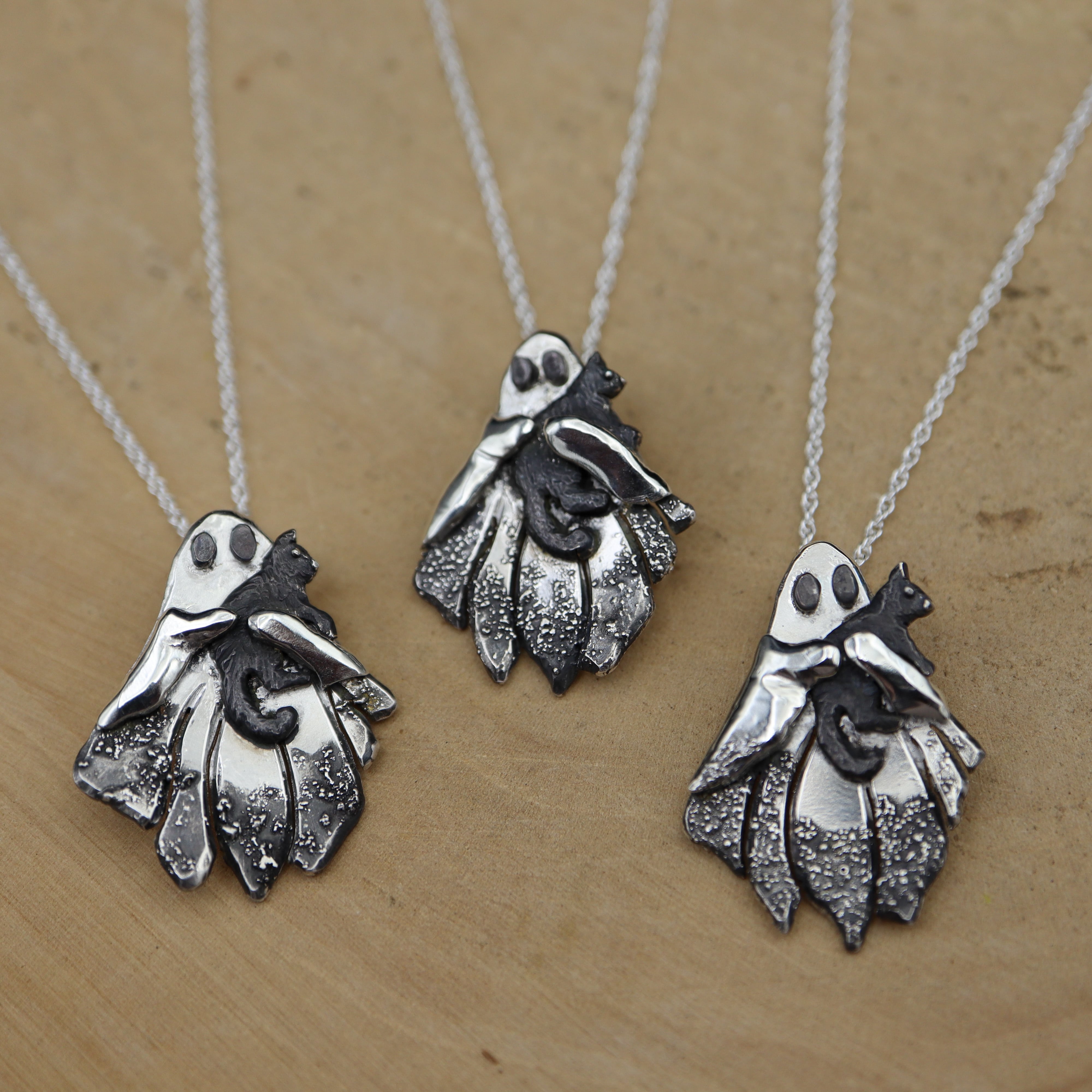 Ghost Holding Their Kitty Necklace