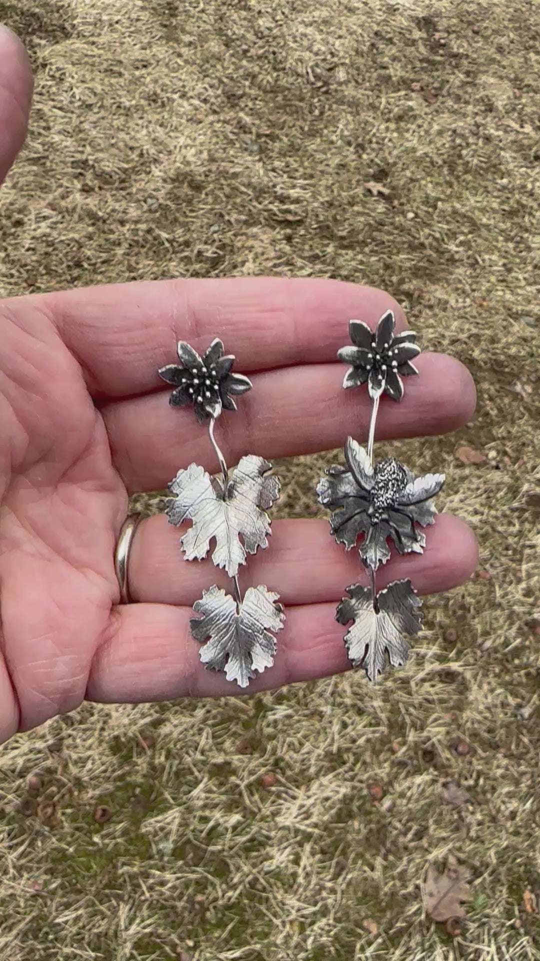 A video showing the handmade sterling silver bee fly and bloodroot dangle earrings.