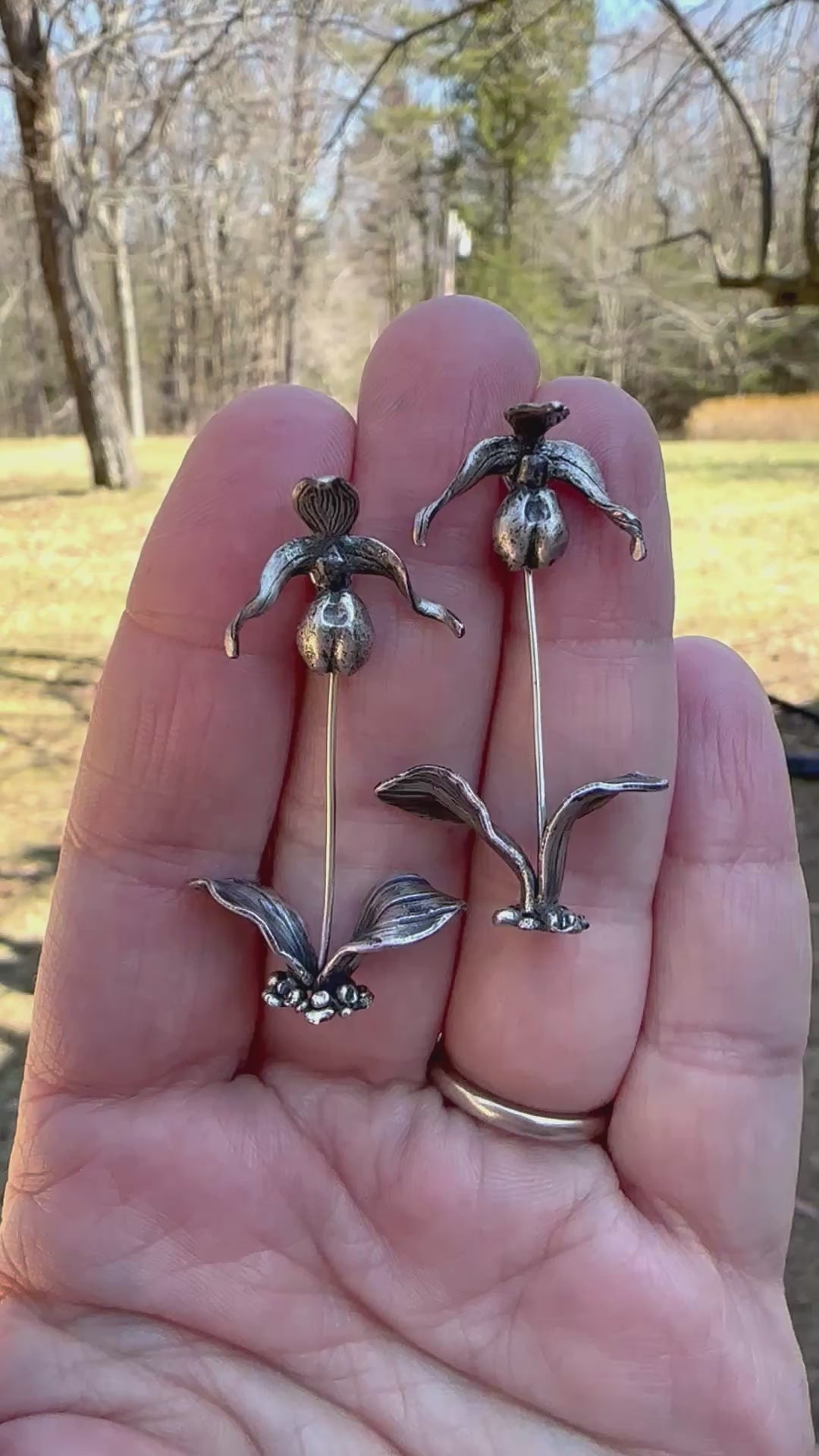 A video showing someone holding the pink lady slipper orchid earrings.