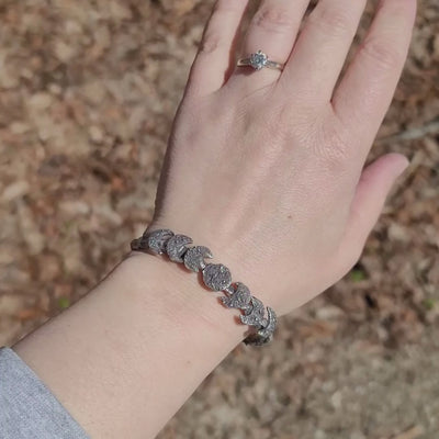 A video showing the sterling silver moon phase bracelet being worn on a wrist. 