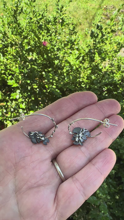 A video showing what the handmade sterling silver goldfish and lily pad hoop earrings look like. 