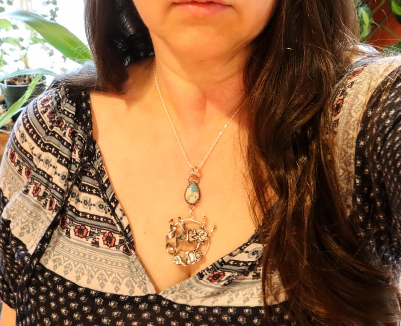 A photo of the clownfish necklace being worn by someone with a dark blue shirt. 