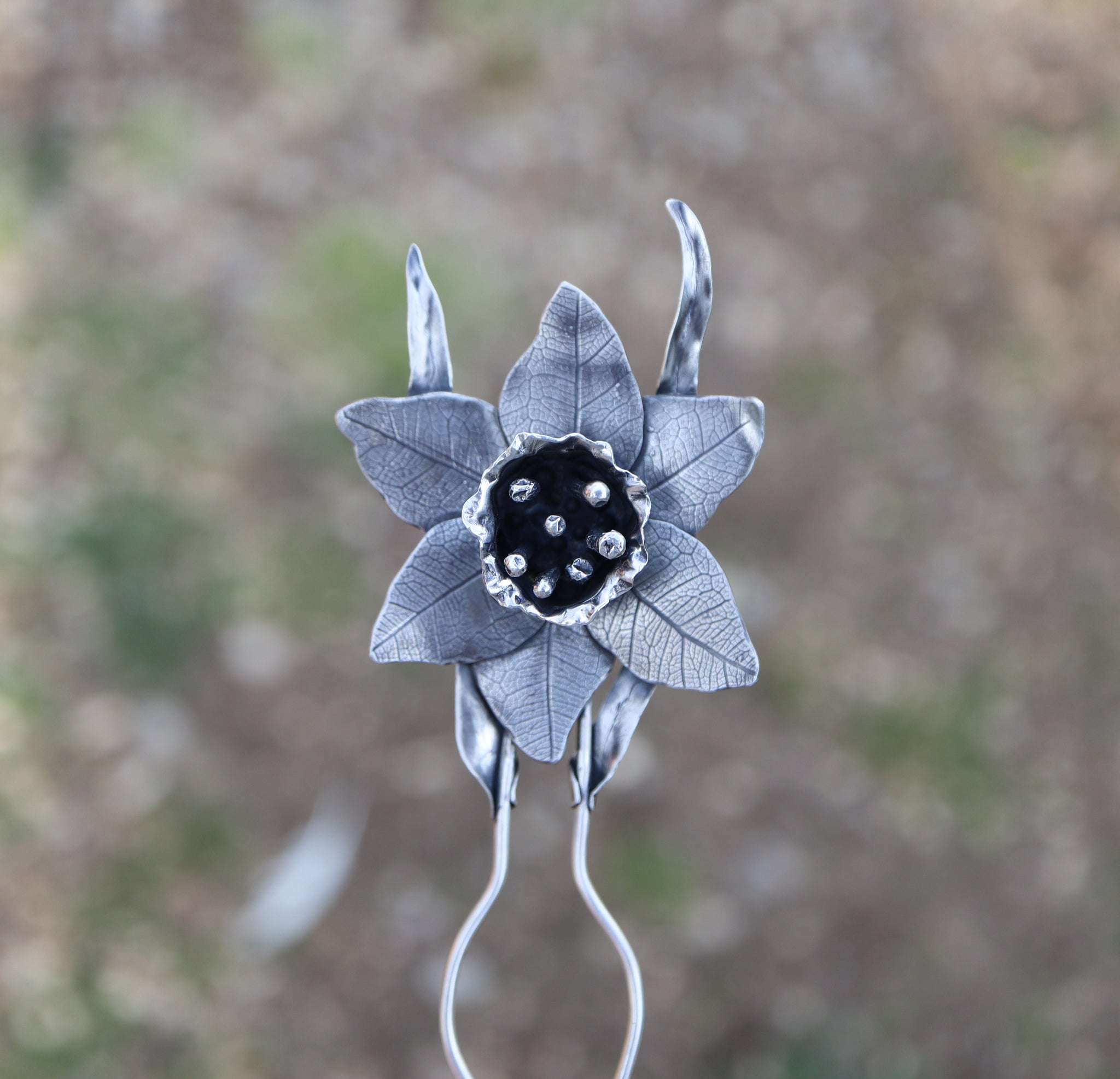 A closer up view of the handmade sterling silver daffodil flower hair pick. 