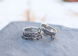 Two rings showing the White Mountains range on them. One of a kind rings made from sterling silver and shown on a piece of dark grey slate. 
