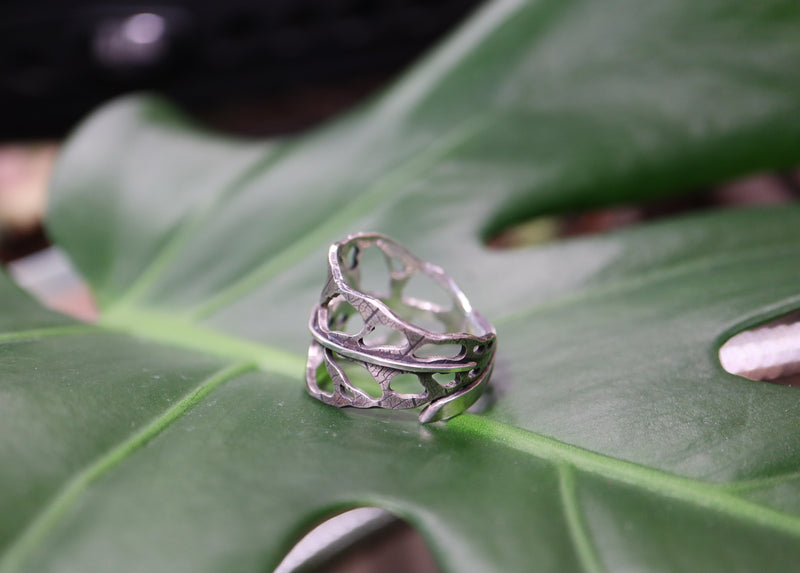 Another side view of the holey, real leaf patterned, monstera obliqua leaf ring. 