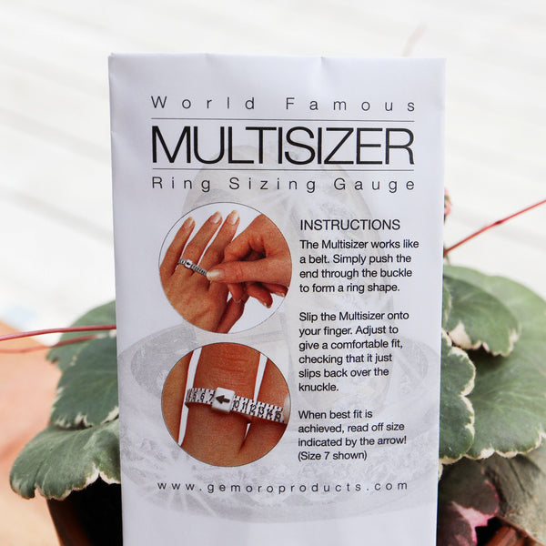 A reusable ring sizer shown in front of a green houseplant in the package.