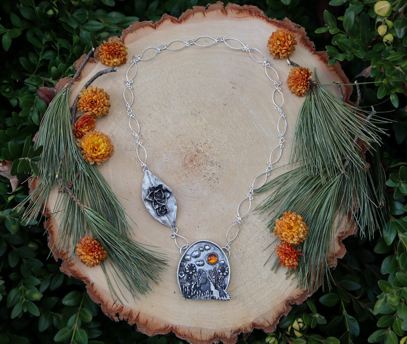 A full view of the handmade necklace shown on a piece of light tan wood.