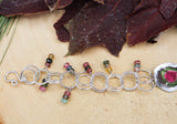 the left side of the bracelet showing all of the circular links and little dangles of rainbow gemstones on each link.