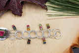 The right side of the bracelet showing all of the circular links and little dangles of rainbow gemstones on each link.